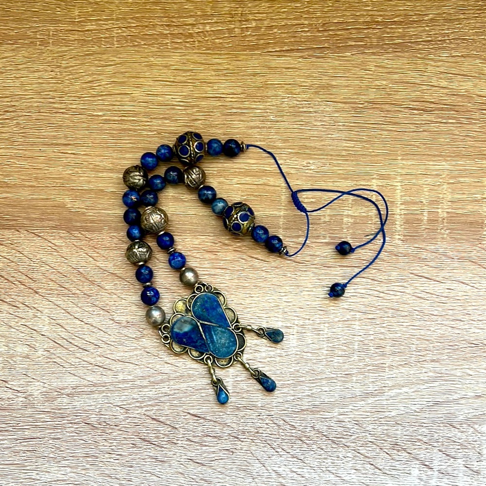 Lapis lazuli necklace beaded with African and Tibetan beads. Size is adjustable.